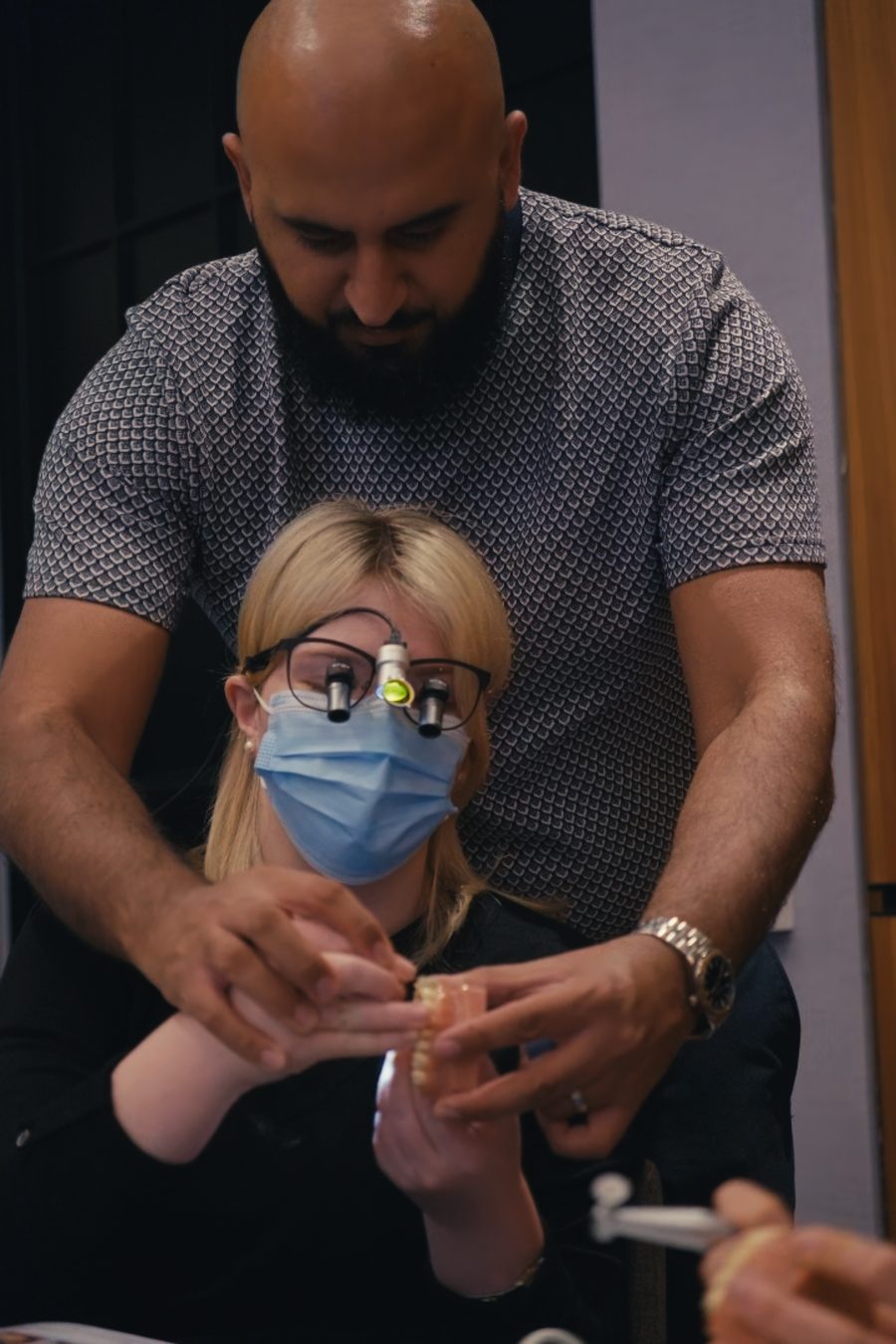 Educator guiding an attendee through a composite layering step