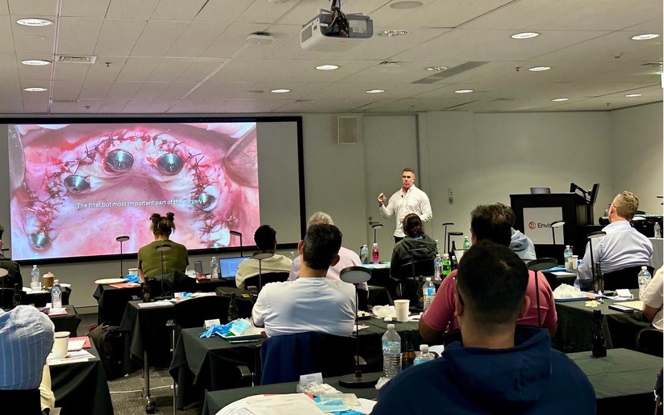 Dentists at an EDA implant masterclass watching a live surgical case