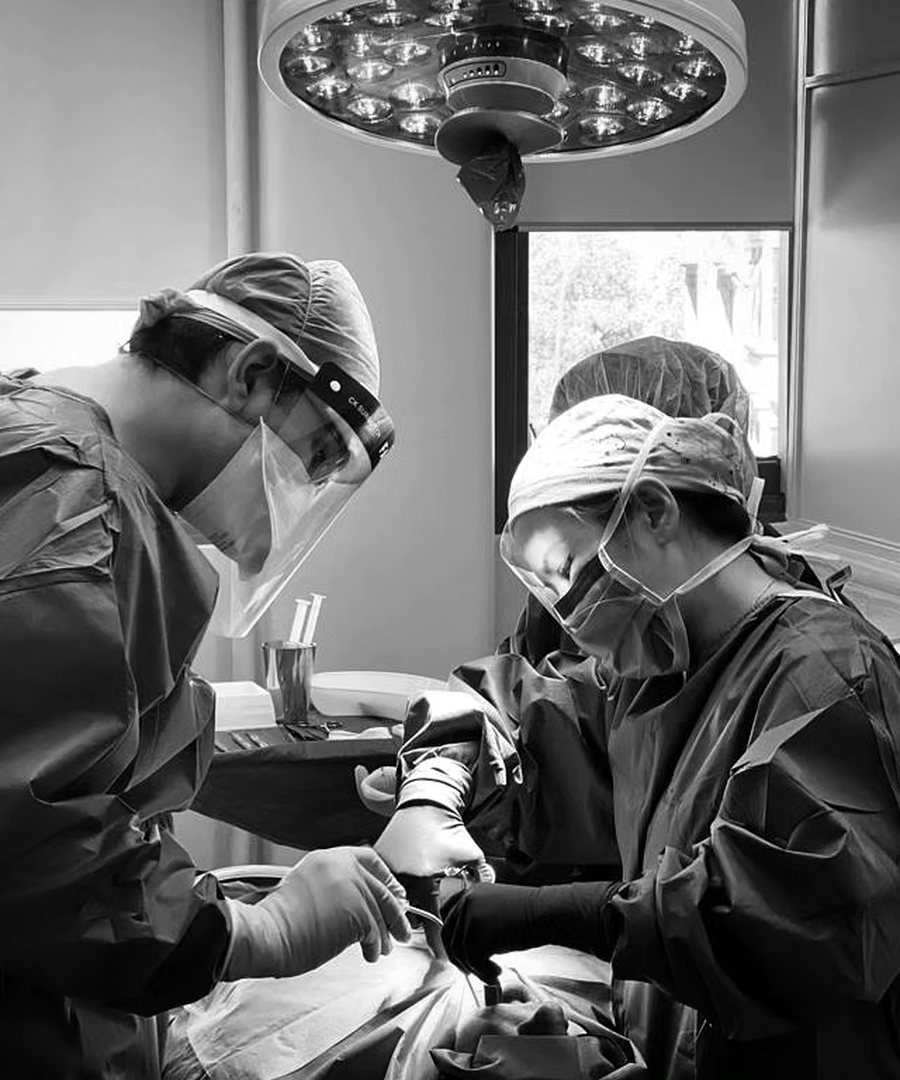 Two clinicians operating together in theatre